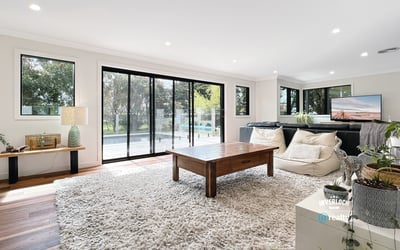 Spacious living area featuring large windows, modern furnishings, and seamless indoor-outdoor flow for relaxation and entertainment.