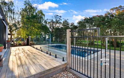 Discover a modern outdoor retreat featuring a pristine pool and expansive nature views, perfect for relaxation.