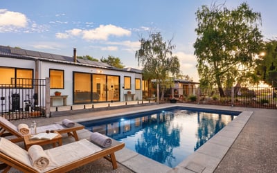 This modern home features a private pool and spacious outdoor area, perfect for entertaining and relaxation.