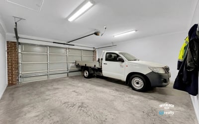 Spacious garage with ample room for storage and vehicle accommodation, featuring seamless concrete flooring.