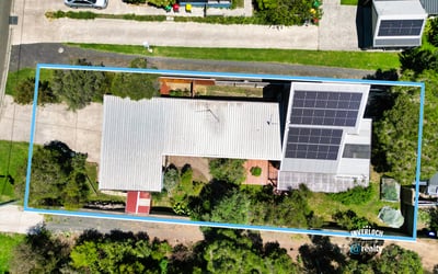 Spacious property featuring solar panels and ample outdoor space, nestled in a vibrant neighborhood.