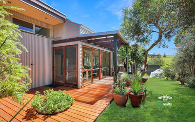 Showcasing a spacious deck surrounded by lush greenery, this property offers a perfect outdoor retreat.