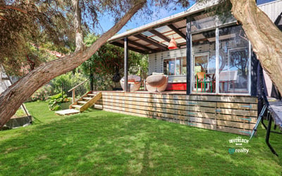 Bright and inviting outdoor space featuring a spacious deck, ideal for relaxation and entertaining.