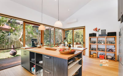 Bright and airy kitchen with expansive windows, featuring modern appliances and a spacious island for entertaining.