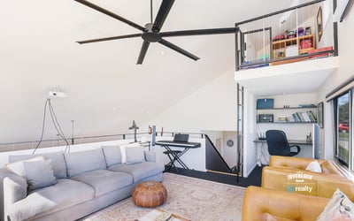 Contemporary loft with abundant natural light, featuring an open layout and versatile office space.
