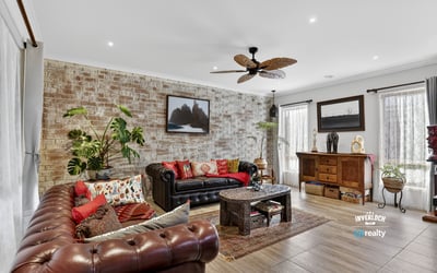 Discover a unique living space featuring exposed brick, vibrant textiles, and natural light, perfect for relaxation.
