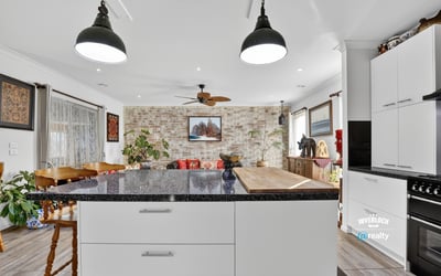 Inviting open-concept kitchen and living area featuring modern finishes and a cozy atmosphere for gatherings.
