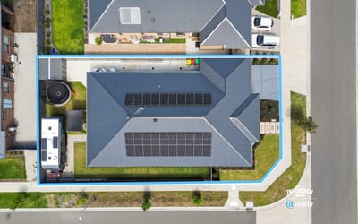 Spacious property featuring solar panels, ample yard space, and convenient access to nearby amenities.