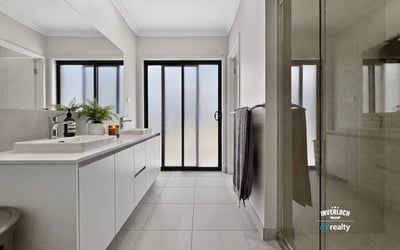 Light-filled bathroom featuring modern fixtures and a spacious layout, perfect for relaxation and convenience.