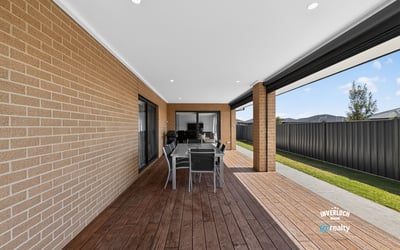 Spacious outdoor patio area perfect for entertaining, featuring a modern design and low-maintenance landscaping.
