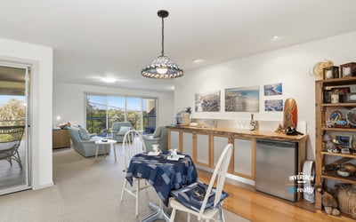Bright, open-plan living space seamlessly connects the kitchen, dining, and cozy lounge area, perfect for entertaining.