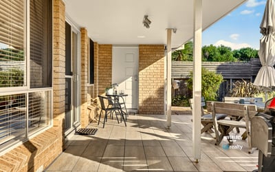 This inviting outdoor space features ample seating and natural light, perfect for relaxation and gatherings.