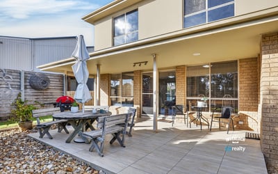 Enjoy outdoor living in this spacious backyard, featuring a patio and ample space for entertaining.