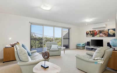 Bright and inviting living space featuring large windows and a seamless connection to the outdoor views.