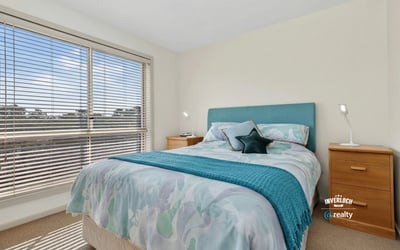 Bright bedroom featuring large windows, contemporary decor, and a cozy atmosphere, perfect for relaxation.