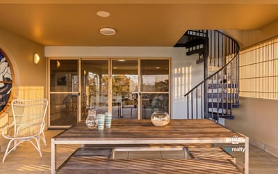 Spacious outdoor patio featuring a spiral staircase, perfect for entertaining and enjoying panoramic views.