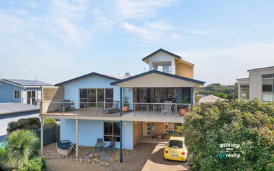 Contemporary coastal home featuring expansive outdoor spaces and panoramic views, perfect for relaxation and entertaining.