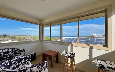 Bright sunroom with panoramic ocean views, perfect for relaxation and enjoying natural light.