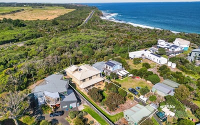 Coastal property featuring stunning ocean views, lush greenery, and easy access to scenic beachfront.