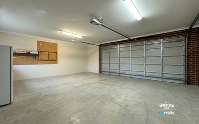 Spacious garage featuring ample storage options and abundant natural light, ideal for vehicles and projects.