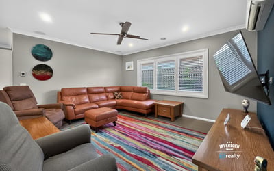 Spacious living area features contemporary furnishings and vibrant decor, perfect for relaxation and entertaining.