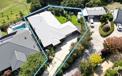 Spacious property featuring a lush yard, pool, and ample parking with a functional layout.