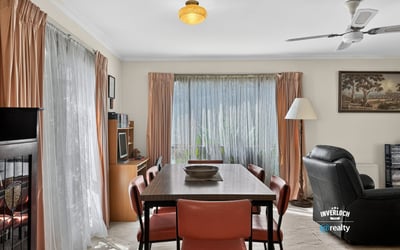 Bright and inviting living space featuring large windows, a dining area, and comfortable seating for relaxation.