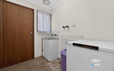 Functional laundry space featuring ample storage and convenient layout for efficient household management.