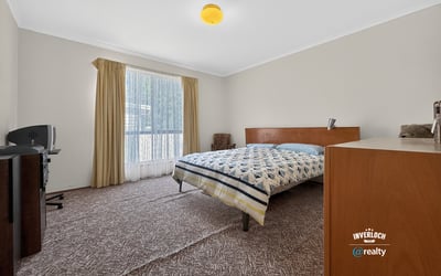 Spacious bedroom featuring large windows, ample natural light, and practical storage solutions for everyday convenience.