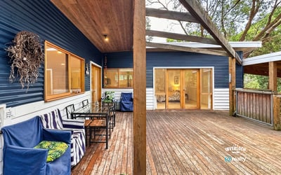 Spacious outdoor deck offers seamless indoor-outdoor living, perfect for entertaining amid a tranquil natural setting.
