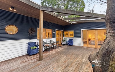 Contemporary home featuring a spacious outdoor deck, perfect for entertaining in a natural setting.