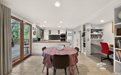 Spacious kitchen with ample natural light, featuring a dining area and convenient workspace for modern living.