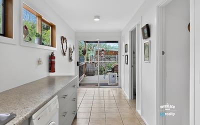 Spacious laundry area flows seamlessly into a bright outdoor patio perfect for entertaining and relaxation.