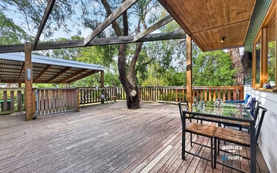 Spacious outdoor deck surrounded by nature, perfect for entertaining or relaxing in a private setting.