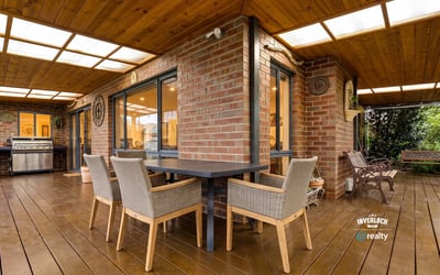 Spacious outdoor patio with dining area and built-in grill, perfect for entertaining and enjoying gatherings.