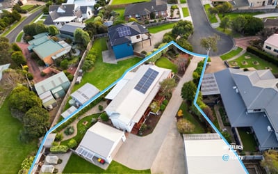 Spacious property featuring a large outdoor area and solar panels, nestled in a modern neighborhood.