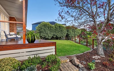 Inviting outdoor space with landscaped garden and seating area, perfect for relaxation and entertaining.