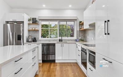 Modern kitchen featuring sleek cabinetry, stainless steel appliances, and abundant natural light for an inviting atmosphere.