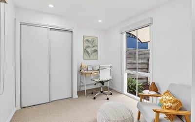 Bright and functional office space featuring natural light, modern furnishings, and streamlined storage solutions for productivity.