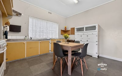 Bright, functional kitchen featuring ample storage and a cozy dining area, perfect for everyday meals.