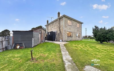 Spacious two-story home with a large yard, ideal for customization and outdoor activities.