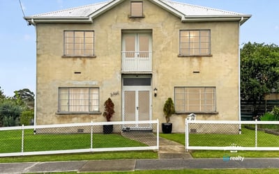 Spacious two-story residence featuring distinct architecture and ample outdoor space for relaxation and activities.