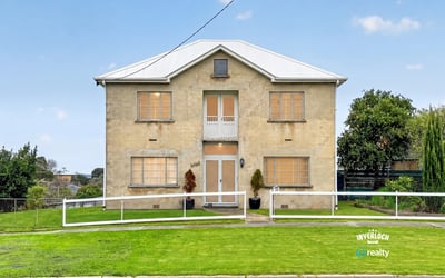 Spacious two-story home with ample yard space, perfect for customization and outdoor living.