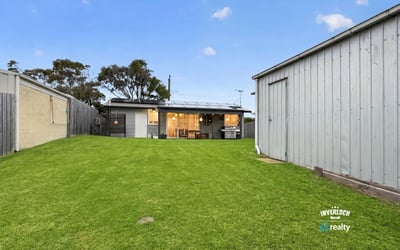 Spacious backyard perfect for outdoor activities, featuring a cozy home with modern amenities and ample storage.