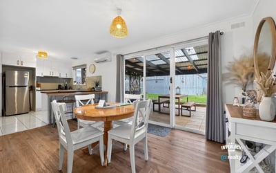 Bright dining area opening to a covered patio, perfect for indoor-outdoor living and entertaining.