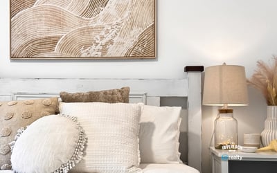 Bright and inviting bedroom featuring textured decor and warm, neutral tones for a cozy atmosphere.