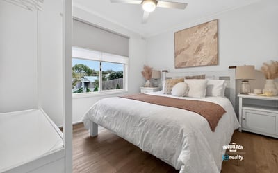This inviting bedroom features a spacious layout, abundant natural light, and contemporary decor for comfortable living.