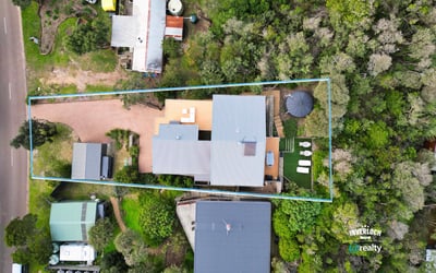 Spacious property surrounded by greenery, featuring ample outdoor space and convenient access to main roads.