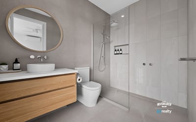 Modern bathroom featuring a spacious walk-in shower, sleek cabinetry, and contemporary finishes throughout.