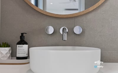 Sleek modern sink with a circular design, complemented by contemporary fixtures and minimalist decor.